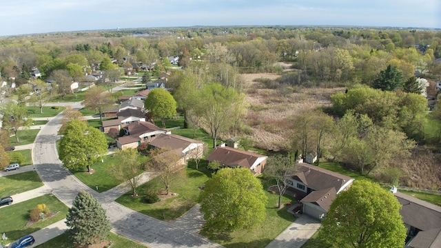 birds eye view of property with a view of trees and a residential view