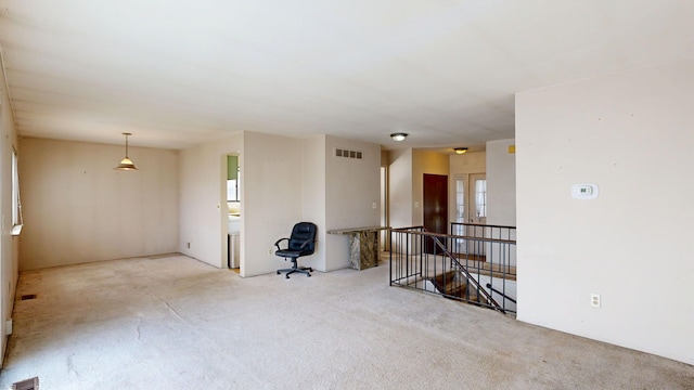 spare room featuring carpet flooring and visible vents