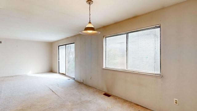 carpeted spare room with visible vents