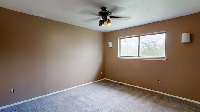 unfurnished room featuring carpet flooring, ceiling fan, and baseboards