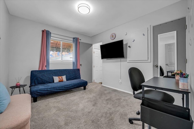 carpeted home office featuring baseboards