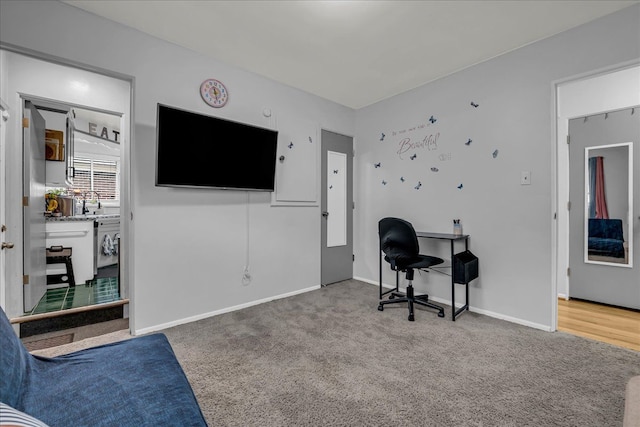 carpeted office space featuring baseboards