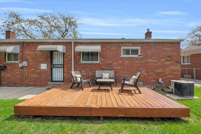 rear view of property featuring brick siding, cooling unit, and a chimney