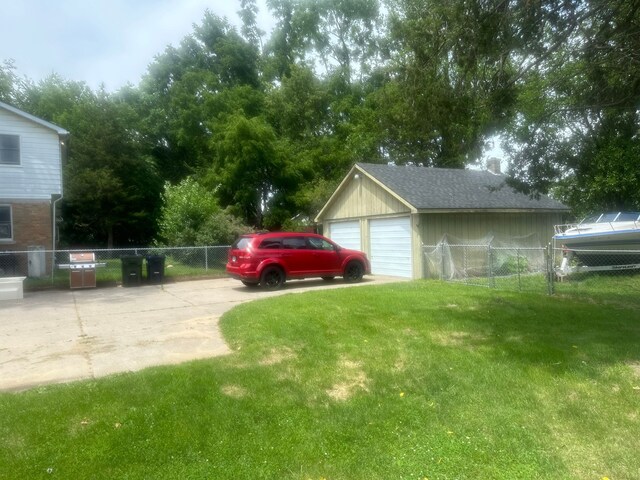 exterior space with an outdoor structure, a garage, and fence