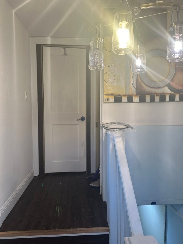 interior space featuring baseboards and wood finished floors