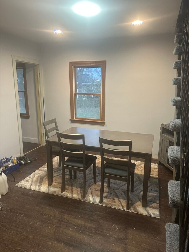 dining space with wood finished floors
