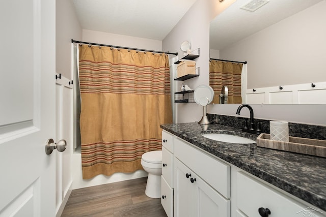9959 Dice Rd, Freeland, MI 48623 - bathroom with visible vents, vanity, wood finished floors, toilet, and shower / bathtub combination with curtain