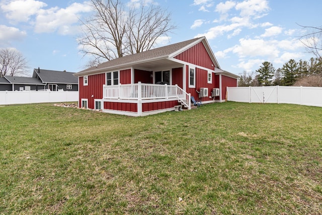 9959 Dice Rd, Freeland, MI 48623 - view of front of home featuring board and batten siding, a deck, a fenced backyard, and a front yard