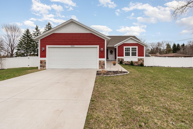 9959 Dice Rd, Freeland, MI 48623 - view of front of house with fence, a front yard, driveway, and stone siding