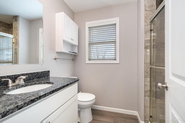 full bathroom with baseboards, wood finished floors, and a stall shower