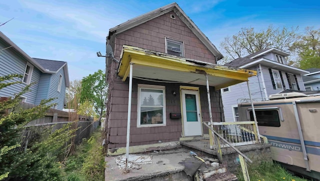 view of front of home featuring crawl space and fence