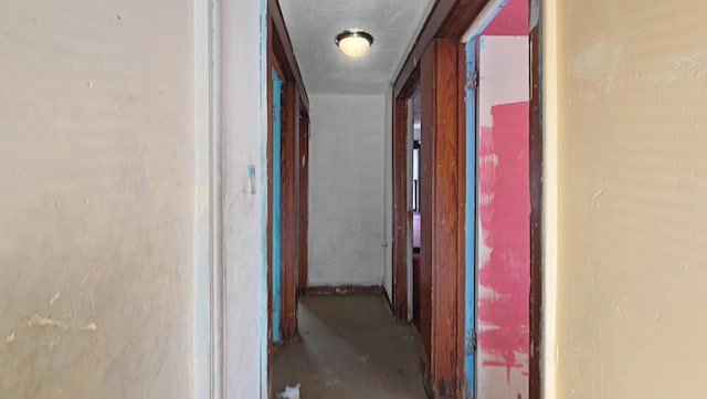 corridor featuring unfinished concrete flooring