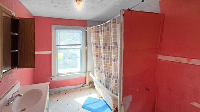 full bath featuring vanity, a textured ceiling, and shower / bath combination with curtain