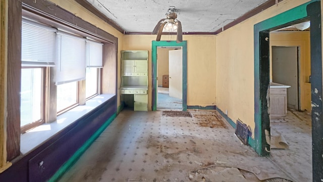 interior space featuring crown molding and baseboards