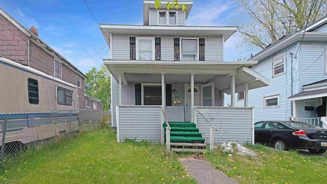 american foursquare style home featuring fence and a porch