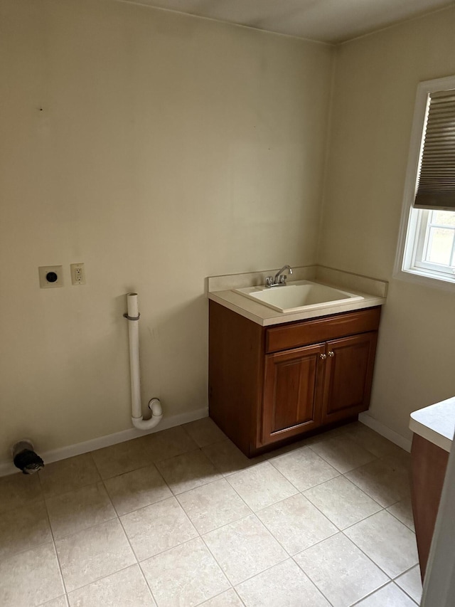 bathroom with vanity, tile patterned flooring, and baseboards