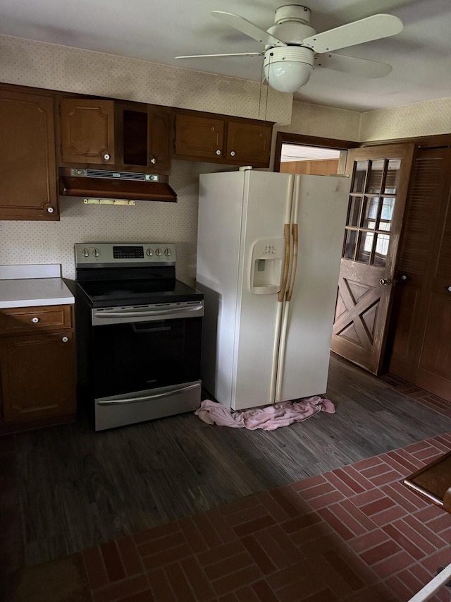 kitchen featuring a ceiling fan, stainless steel electric range oven, white refrigerator with ice dispenser, light countertops, and under cabinet range hood