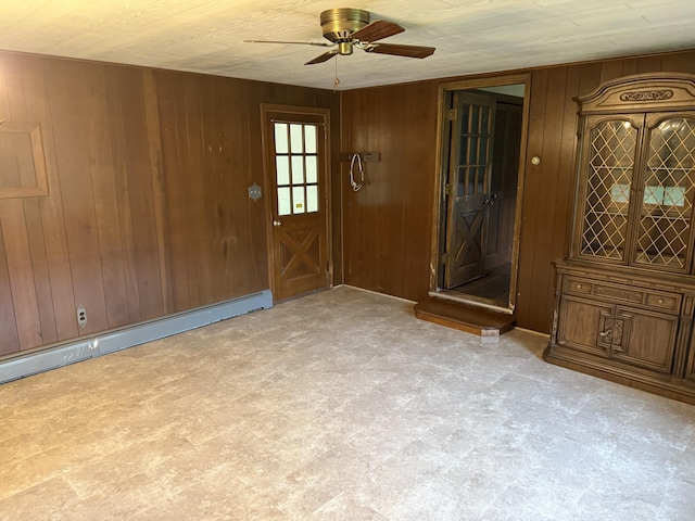 6411 Custer Rd, Carsonville, MI 48419 - foyer entrance featuring ceiling fan, wood walls, a baseboard heating unit, and tile patterned floors