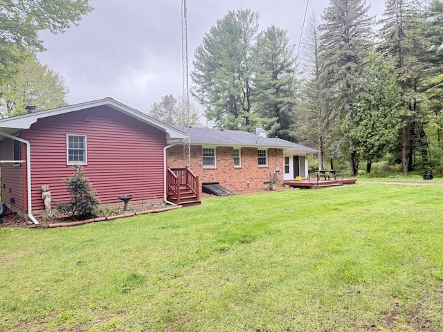 6411 Custer Rd, Carsonville, MI 48419 - back of property featuring a deck, a yard, and brick siding