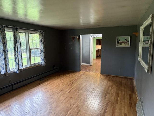 6411 Custer Rd, Carsonville, MI 48419 - spare room featuring baseboard heating and light wood-style floors