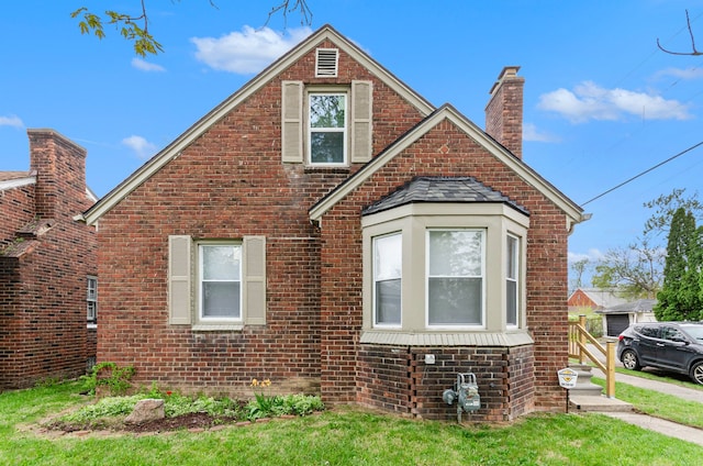 18900 Asbury Park, Detroit, MI 48235 - view of front facade featuring brick siding, a chimney, and a front yard