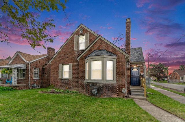 18900 Asbury Park, Detroit, MI 48235 - view of front of house with brick siding, a chimney, and a front yard