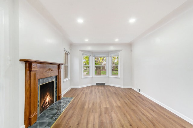 18900 Asbury Park, Detroit, MI 48235 - unfurnished living room with recessed lighting, a fireplace, visible vents, and wood finished floors