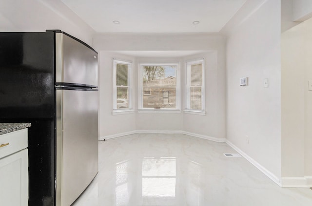18900 Asbury Park, Detroit, MI 48235 - kitchen featuring freestanding refrigerator, white cabinets, visible vents, stone counters, and baseboards