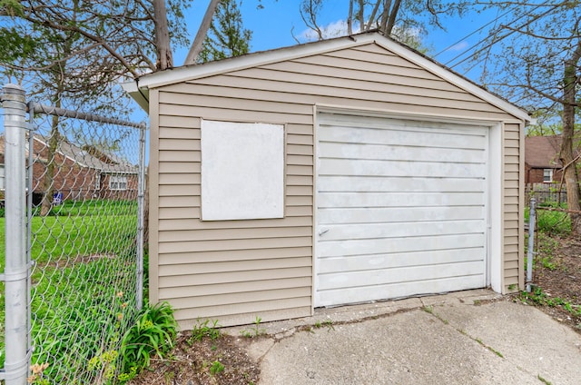 18900 Asbury Park, Detroit, MI 48235 - detached garage featuring driveway, fence, and a shed