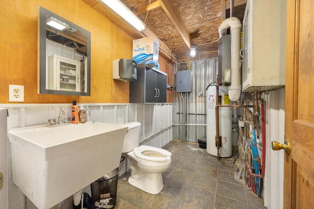 bathroom featuring toilet, water heater, tile patterned flooring, and electric panel