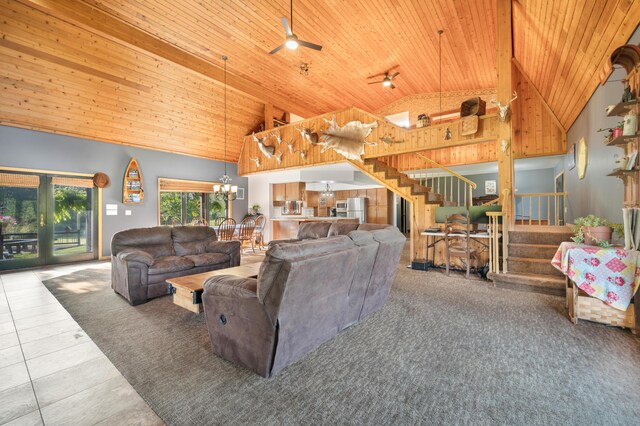 living room with tile patterned flooring, stairway, high vaulted ceiling, wooden ceiling, and ceiling fan with notable chandelier