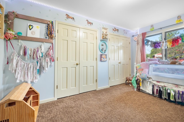 bedroom featuring two closets, carpet flooring, and baseboards