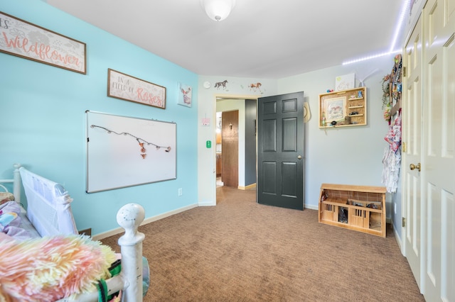 carpeted bedroom featuring baseboards