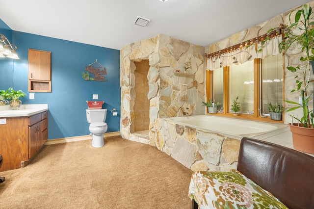 full bathroom with vanity, a bath, visible vents, and toilet