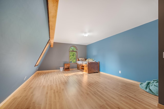 bonus room featuring baseboards and wood finished floors