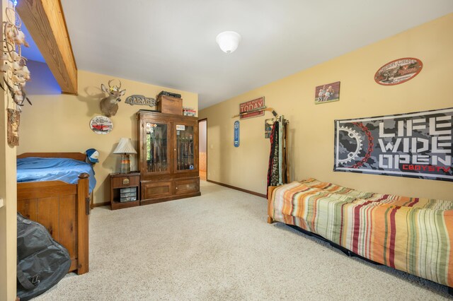 carpeted bedroom featuring baseboards