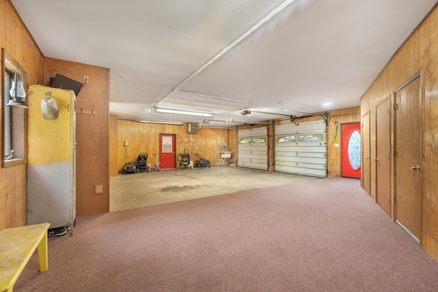 garage featuring wood walls and a garage door opener