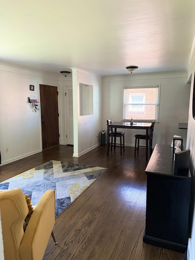25296 Ronald St, Roseville, MI 48066 - living room featuring dark wood-style flooring and baseboards