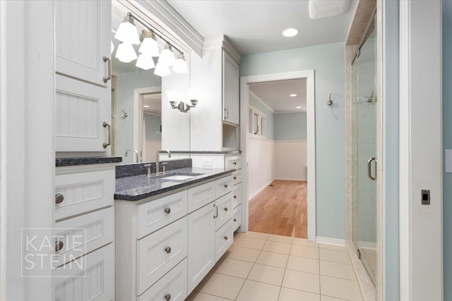 bathroom featuring vanity, tile patterned flooring, and a stall shower