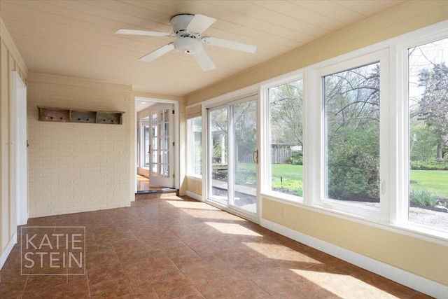 unfurnished sunroom featuring brick wall