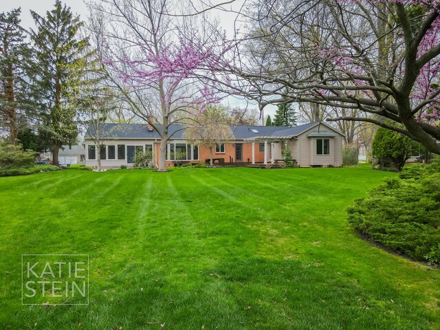 rear view of house featuring a yard