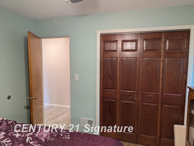 unfurnished bedroom featuring a closet, light wood-style flooring, and visible vents