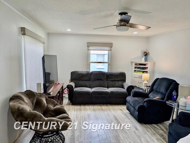 living area with ceiling fan, a textured ceiling, light wood finished floors, ornamental molding, and recessed lighting