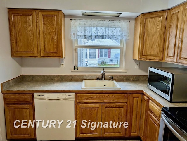 kitchen with brown cabinets, stainless steel appliances, and a sink
