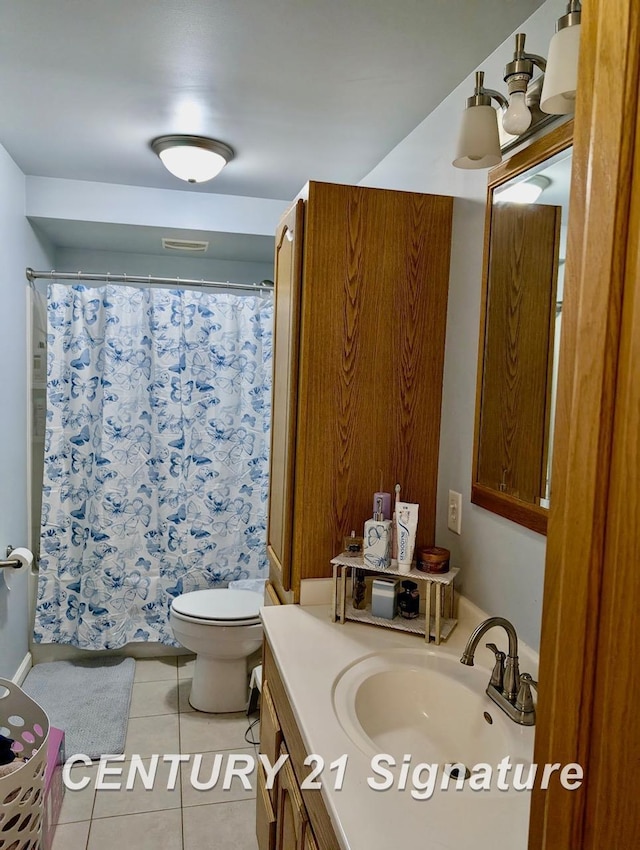 bathroom featuring vanity, tile patterned flooring, toilet, and curtained shower