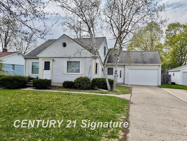 view of front of home with an attached garage, driveway, and a front yard