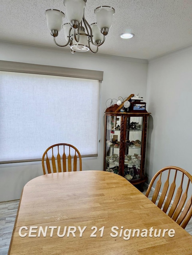dining room with recessed lighting, a textured ceiling, a chandelier, and wood finished floors