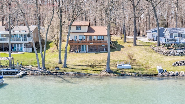 1704 Little Dr, Horton, MI 49246 - back of house featuring a lawn and a deck with water view