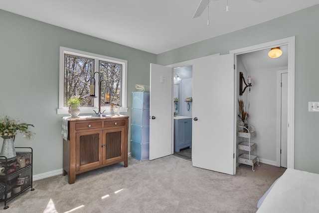 1704 Little Dr, Horton, MI 49246 - bedroom featuring baseboards, connected bathroom, and light carpet