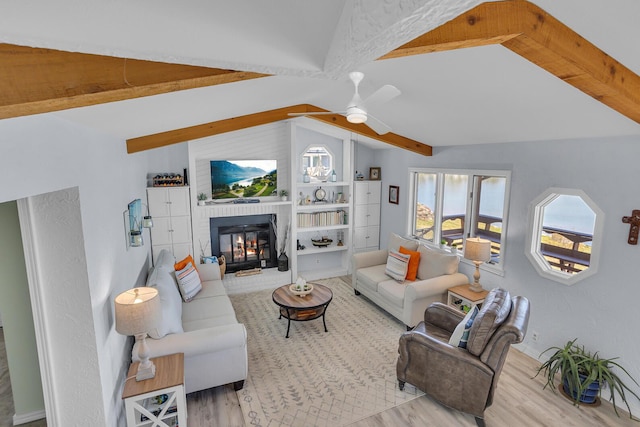 1704 Little Dr, Horton, MI 49246 - living area with a ceiling fan, a brick fireplace, lofted ceiling with beams, and wood finished floors